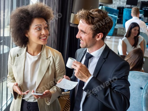 Preview: Young couple of professionals chatting during a coffee break