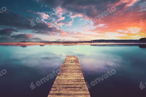 Preview: Colorful Sunset Sunrise Dramatic Sky Above Wooden Boards Pier On Calm Water Of Lake, River. Nature