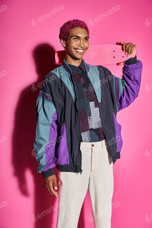 Preview: cheerful young male model posing unnaturally and smiling weirdly holding skateboard on shoulder