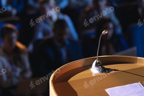 Preview: Close up of podium with speaker in auditorium