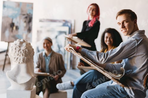Preview: Young multiracial students drawing plaster bust in art school