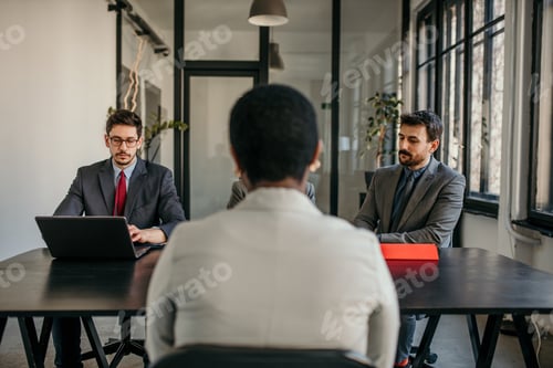 Preview: Businesswoman having job interview with two businessmen