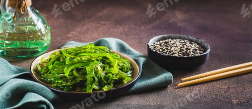 Preview: Traditional fresh seaweed and sesame salad on a plate on the table web banner