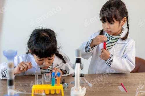 Preview: education, science, chemistry and children concept kids with test tube making experiment