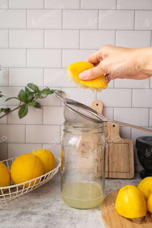 Preview: hand is squeezing lemon juice for making drink or cooking.