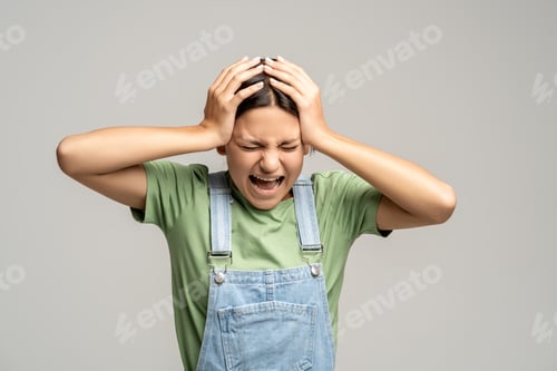 Preview: Unhappy stressed teenager in despair ready to shout, cry of failure, problem, crisis, bad news