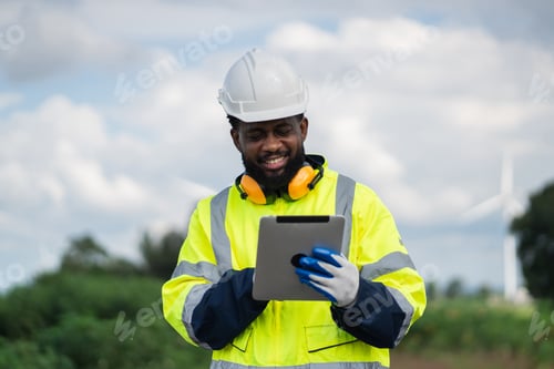 Preview: Service engineers checking system of windmill. Clean and Renewable energy concept.