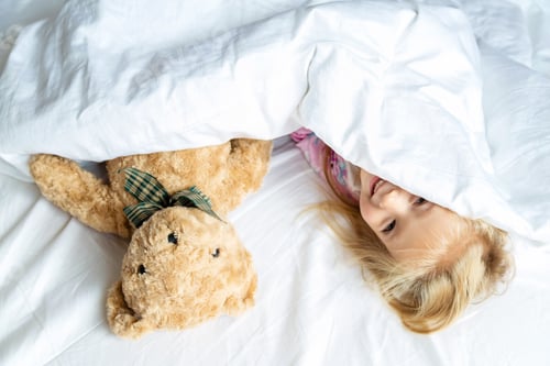 Preview: Little girl and teddy bear lying in the bed