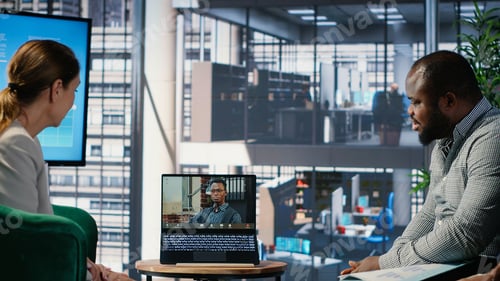 Preview: Multicultural group interacting in a corporate video call in a boardroom