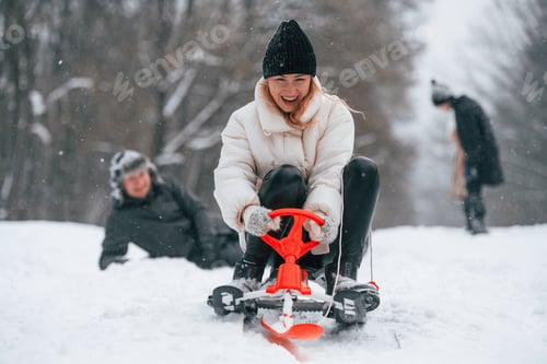 Preview: Woman is on sled ride. Happy family is outdoors, enjoying snow time at winter together