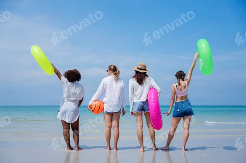 Preview: Happy children laughing and enjoying at beach. Teenage playing with friends at the sea.
