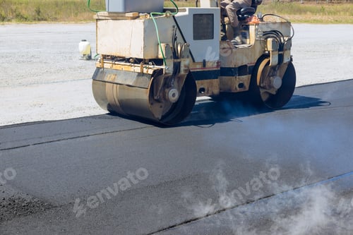 Preview: Worker uses asphalt roller is laying asphalt to road