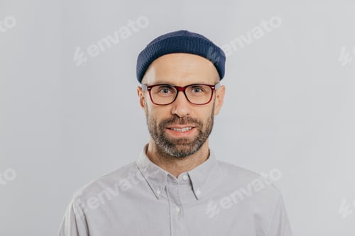 Preview: Headshot of handsome unshaven man wears transparent glasses, headgear