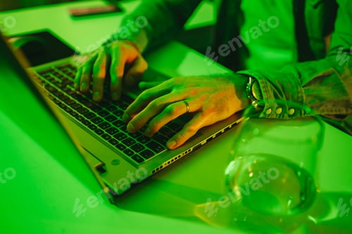 Preview: Close up of a senior developer's hands typing and programming on a laptop.