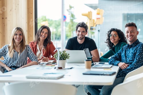 Preview: Successful business team sitting around laptop for presentation of work