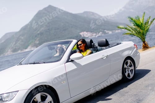 Preview: Young women in white cabriolet car driving everywhere and looking for freedom and fun