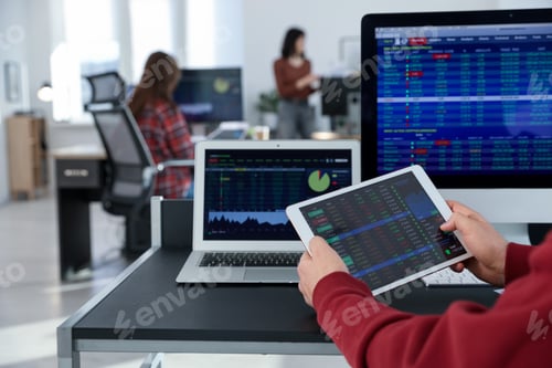 Preview: Stock exchange. Man working at desk in office, closeup