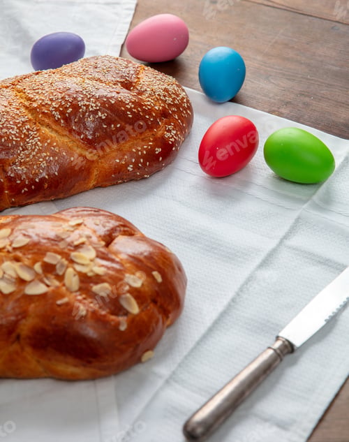 Preview: Easter sweet bread, two tsoureki braids and colorful Easter eggs on the table