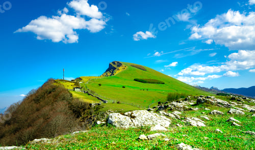 Preview: Landscape of rock mountain. Hill with beautiful sky and white clouds on sunny day. Farming ranch.