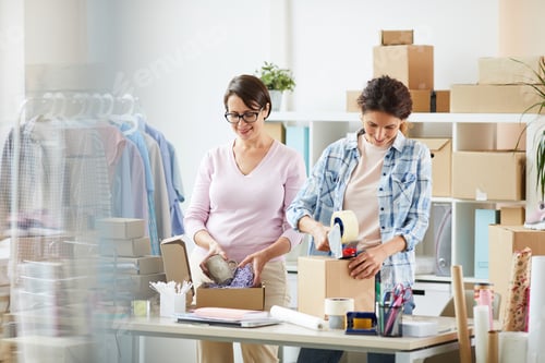 Preview: Two young women packing parcels for online clients