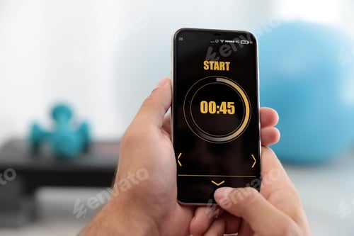 Preview: Man using fitness app on smartphone indoors, closeup