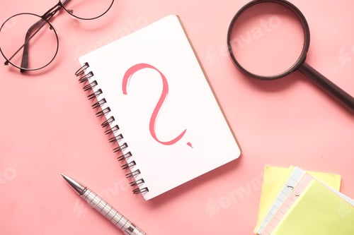 Preview: high angle view of question mark on paper on office desk
