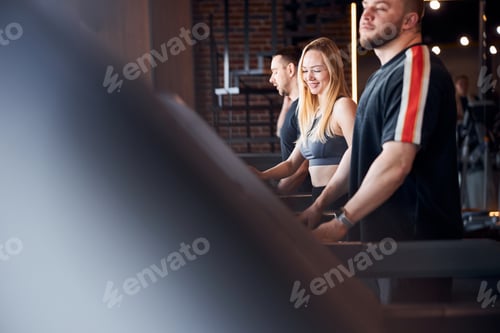 Preview: Smiley blonde lady exercising on a treadmill