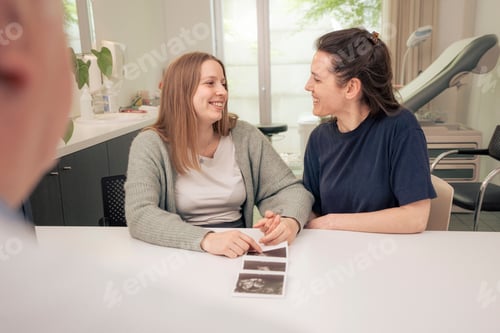 Preview: Loving lesbian couple sharing an intimate moment in a clinic.