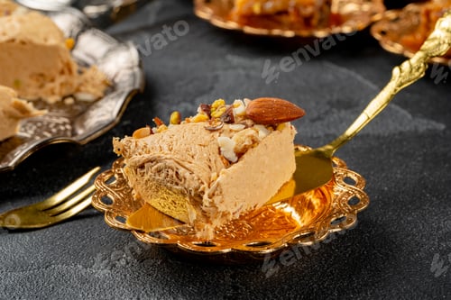 Preview: Piece of halva dessert on golden spatula