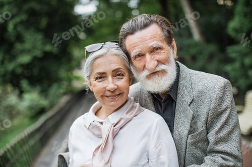 Preview: Caucasian senior couple walking at park in embrace