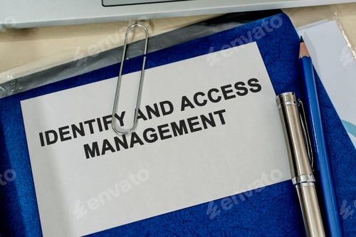 Preview: Top view of a folder labelled "IDENTIFY AND ACCESS MANAGEMENT" on a desk in the office