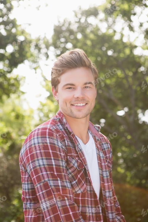 Preview: Handsome hipster smiling at camera on a sunny day