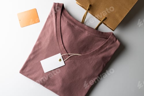 Preview: Close up of tshirt with tag and copy space on white background