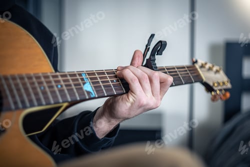 Preview: Close-up, male hands are playing the guitar.