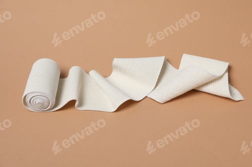 Preview: Help during an injury, elastic bandage on beige background