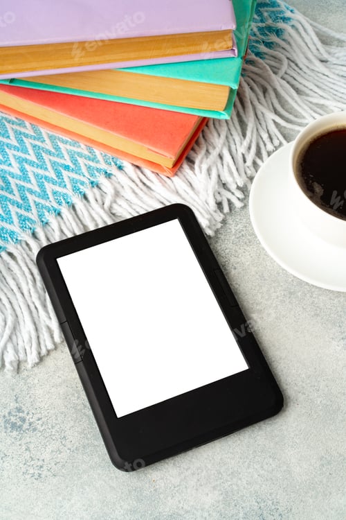 Preview: Composition with modern e-book reader, hardcover book and cup of coffee on table