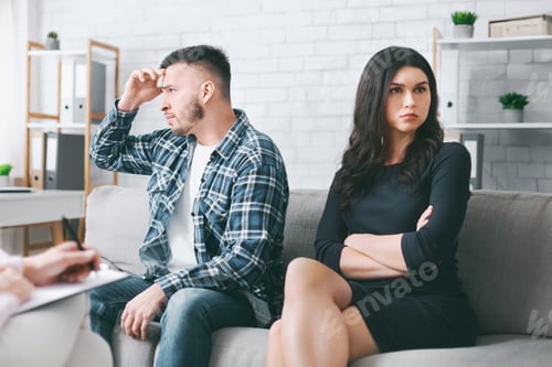 Preview: Upset Man and Woman Sitting on Couch During Therapy Session