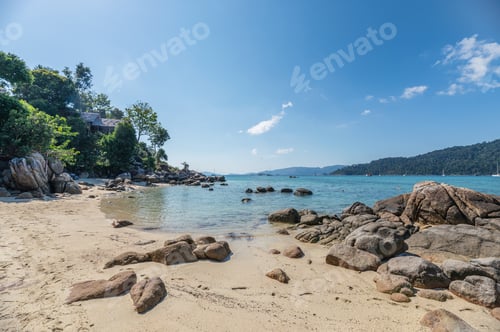 Preview: Rocks on coastline with resort on hill at Lipe