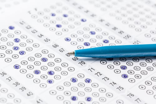 Preview: Students complete test using answer sheet and blue pen in classroom setting during exam period