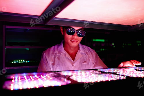 Preview: Technician wearing protective goggles in LED factory