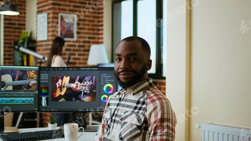Preview: Male filmmaker editing video montage on professional software