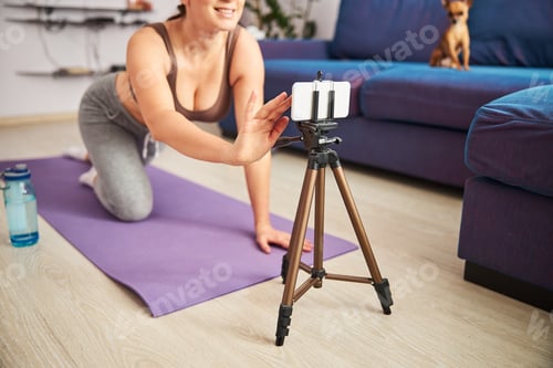 Preview: Happy pretty lady training online on cell phone