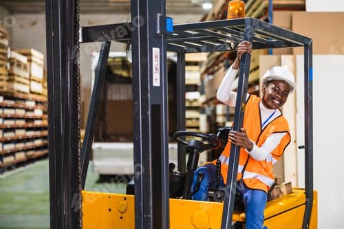Preview: Female worker operating forklift in lumberyard warehouse