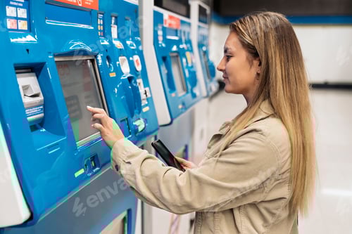 Preview: Woman Using Touchscreen Device in Public Setting