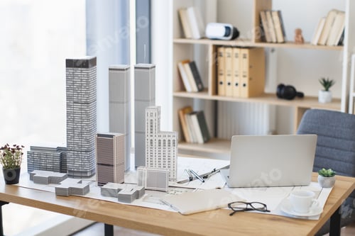 Preview: Modern office desk with architectural model and laptop setup
