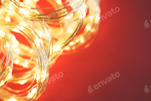 Preview: christmas beautifull shiny gold garland on a red background. sparkle festive background