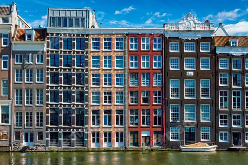 Preview: houses and boat on Amsterdam canal Damrak with reflection. Ams