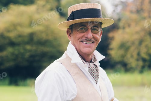 Preview: Smiling Senior Man In Suit And Hat Enjoying His Estate.