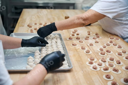 Preview: Kitchen employees make dumplings from minced meat and dough