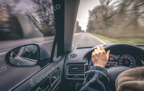 Preview: Woman driver's hands on a car steering wheel.